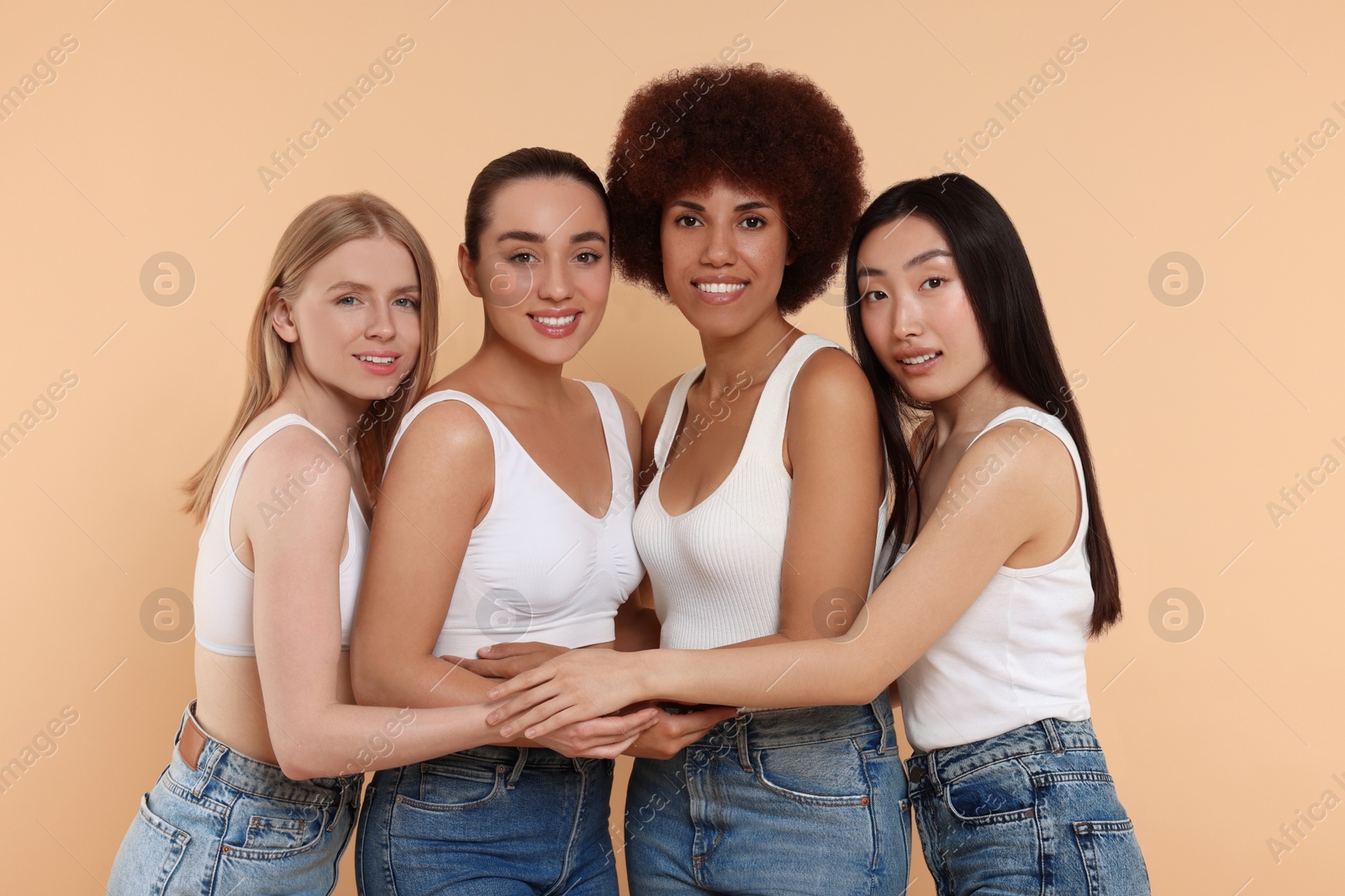 Photo of Group of beautiful young women on beige background