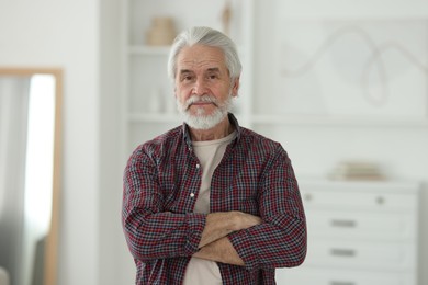 Portrait of happy grandpa with grey hair indoors