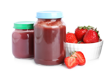 Photo of Jars with baby food and fresh strawberries on white background