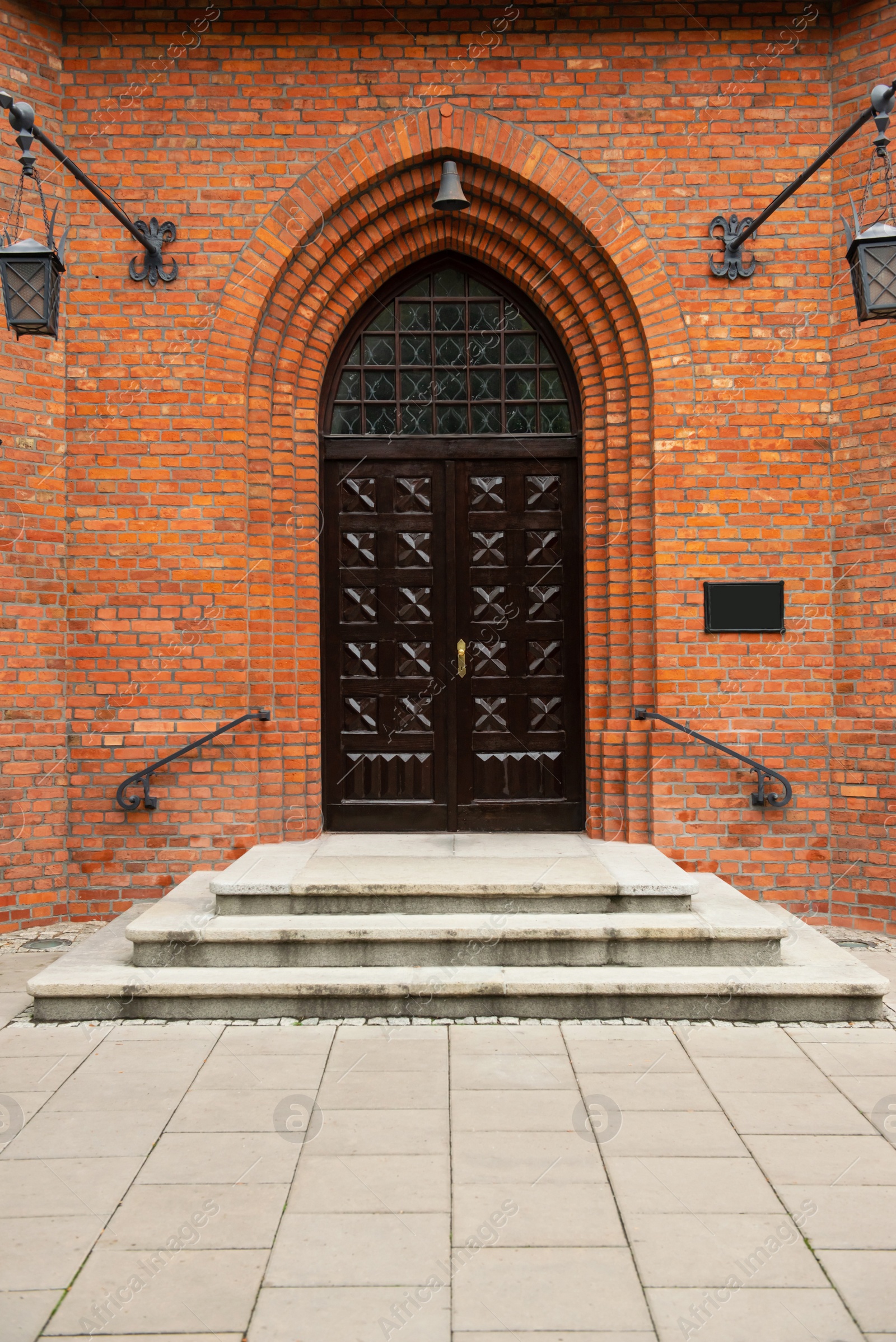 Photo of Entrance of building with beautiful arched wooden door