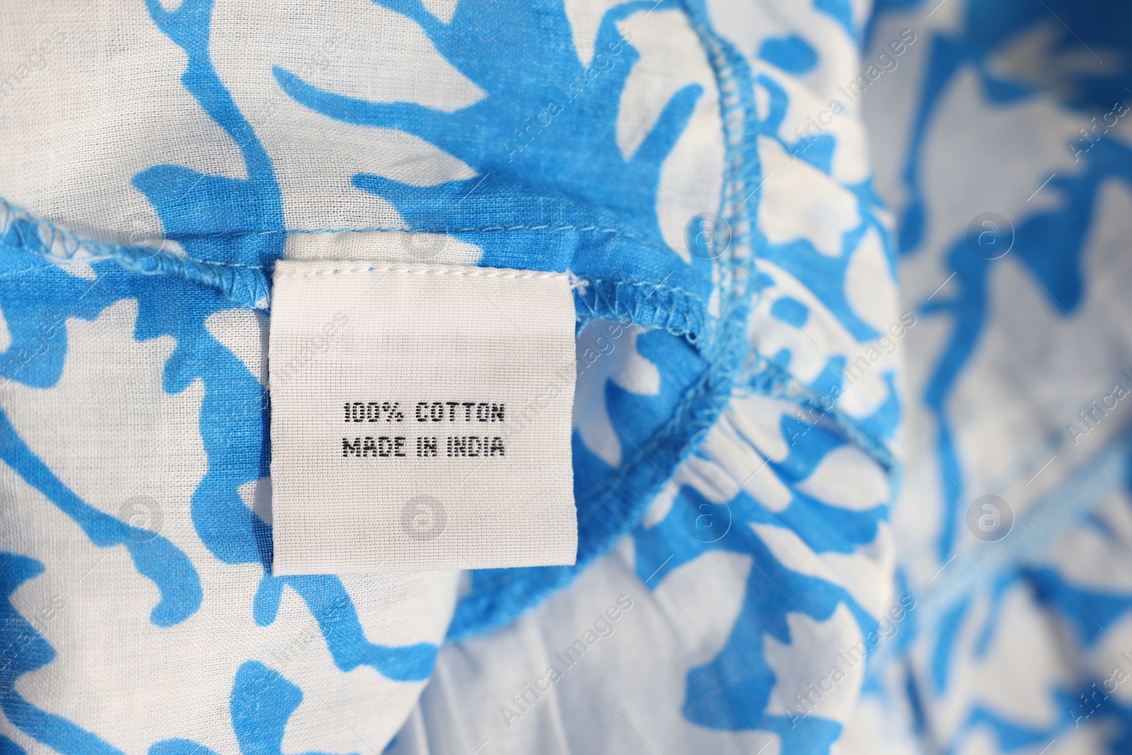 Photo of Clothing label on color garment, closeup view