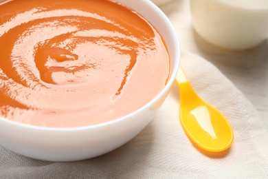 Photo of Healthy baby food in bowl, closeup view