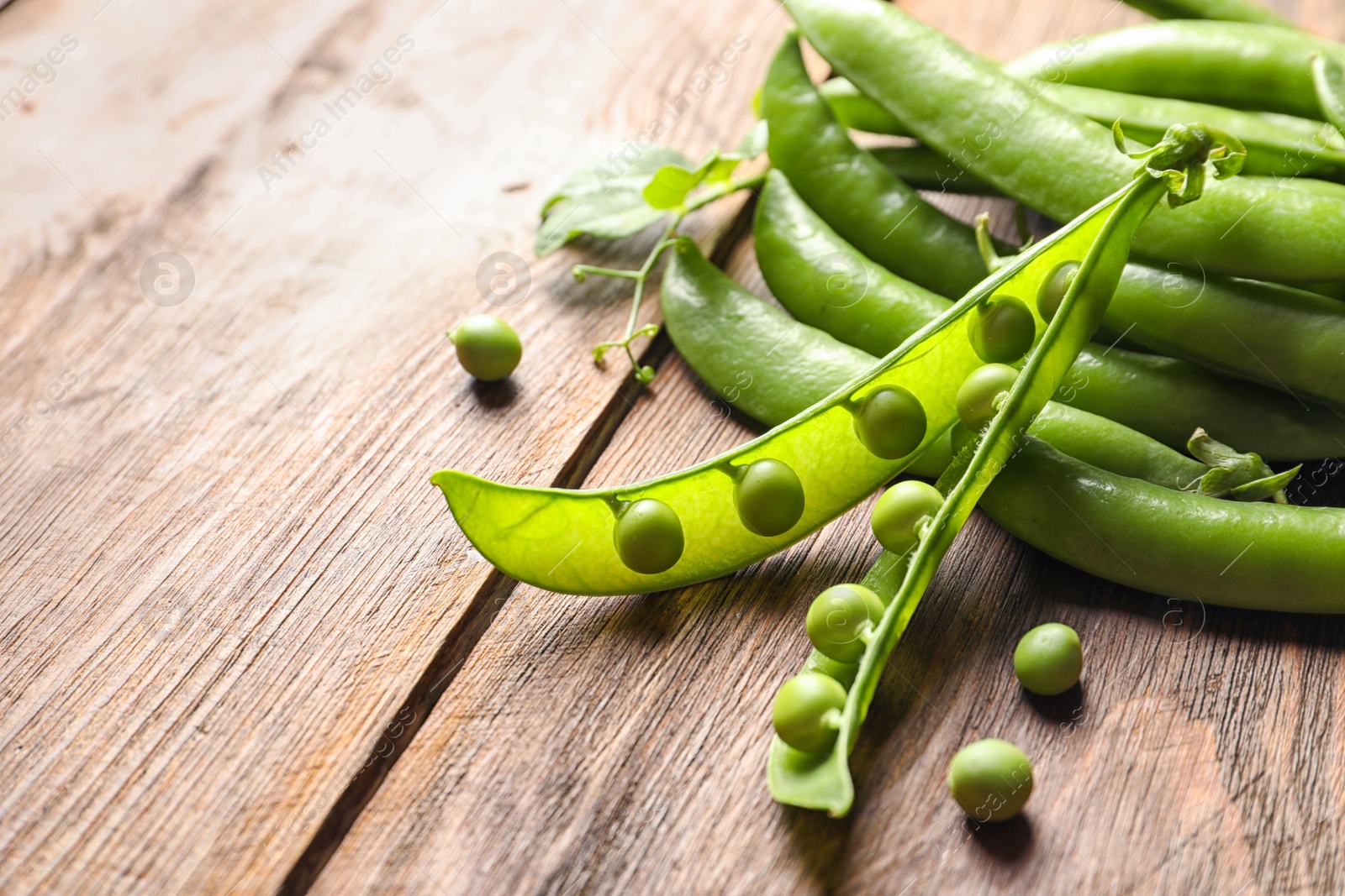 Photo of Fresh green peas on wooden background, closeup