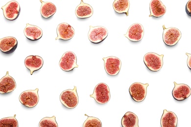 Cut ripe figs on white background, top view