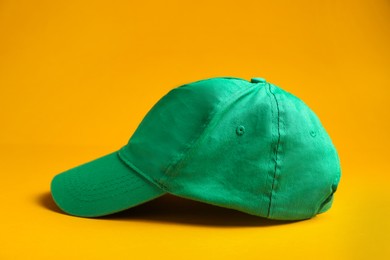 Photo of Baseball cap on yellow background. Mock up for design