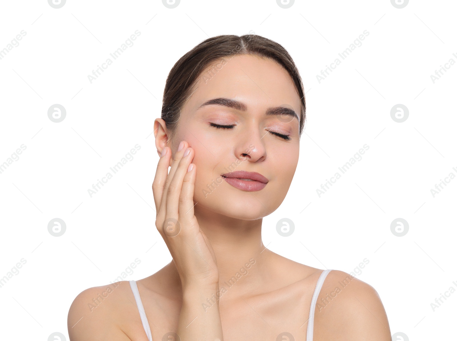 Photo of Young woman applying cream under eye on white background