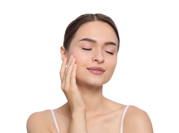 Photo of Young woman applying cream under eye on white background