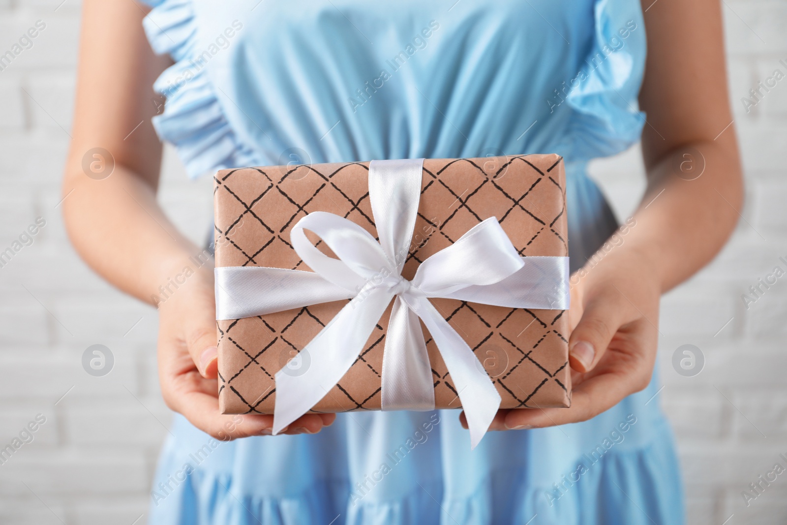 Photo of Woman holding beautiful gift box, closeup