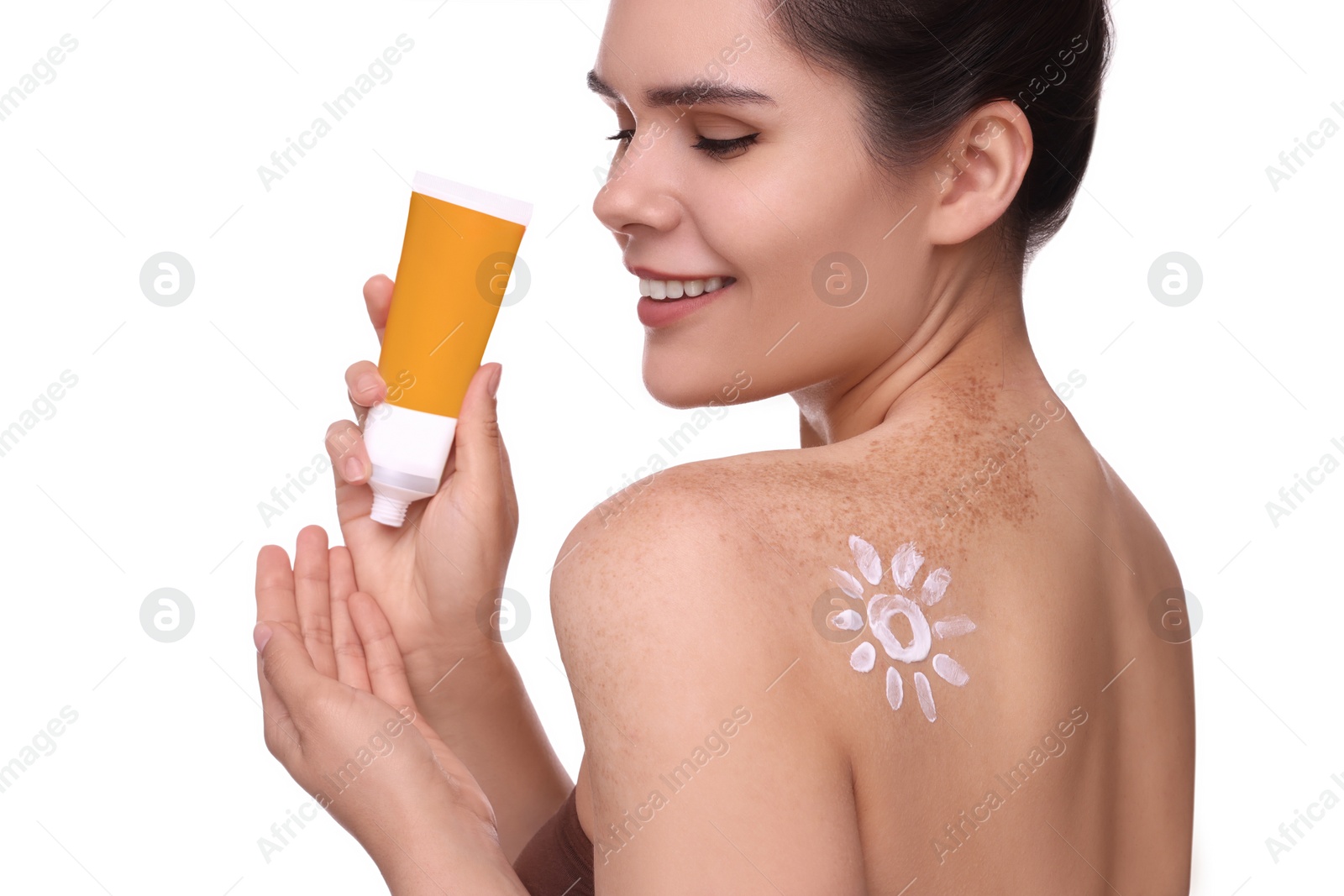 Photo of Beautiful young woman holding tube of sun protection cream against white background, closeup