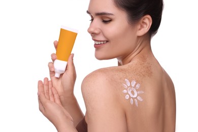 Photo of Beautiful young woman holding tube of sun protection cream against white background, closeup