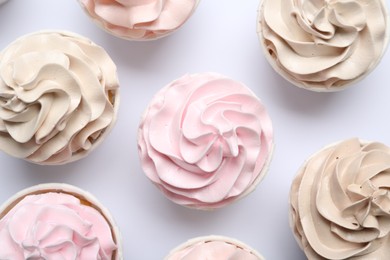 Many tasty cupcakes on white background, flat lay