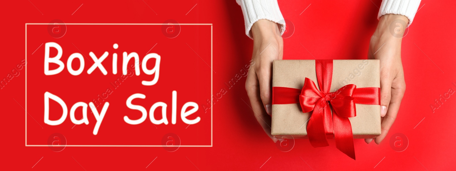 Image of Boxing day sale. Top view of woman with gift on red background, banner design