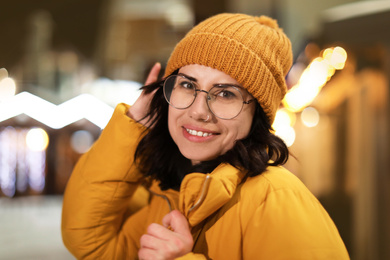 Photo of Beautiful young woman on city street. Winter vacation