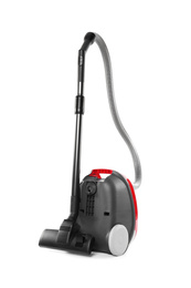 Modern red vacuum cleaner isolated on white