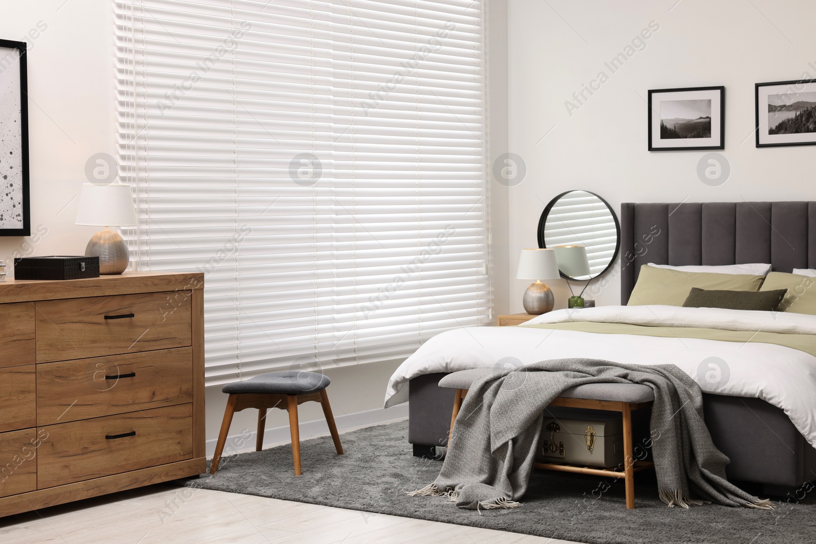 Photo of Window with horizontal blinds and comfortable bed in room