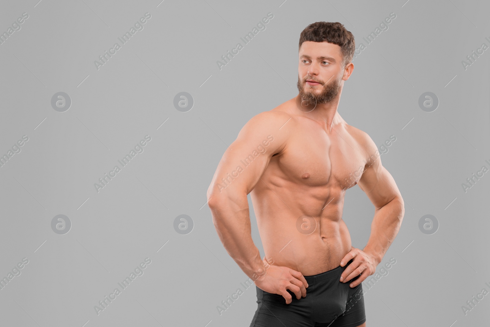Photo of Handsome muscular man on light grey background, space for text. Sexy body