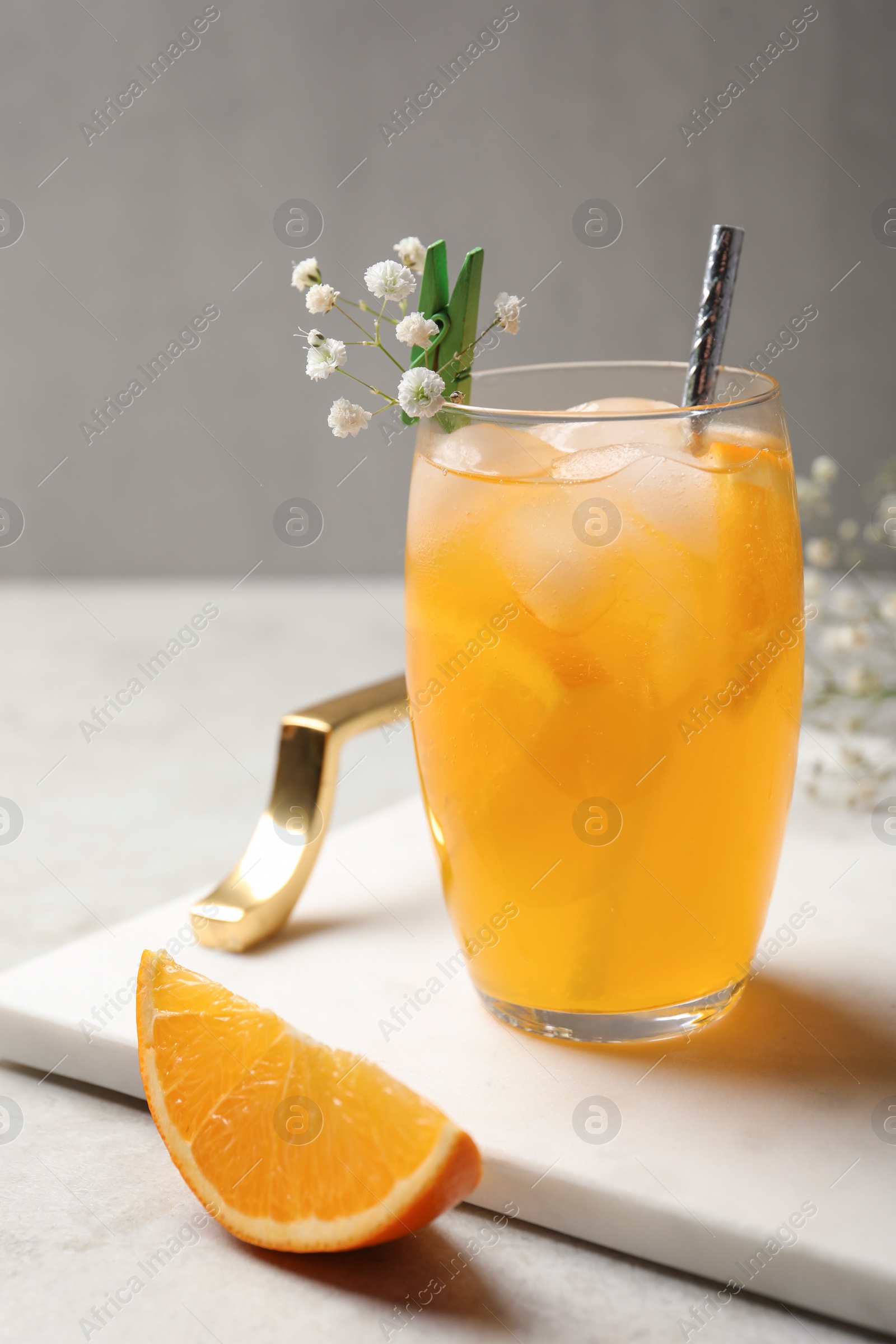 Photo of Delicious orange soda water in glass on tray