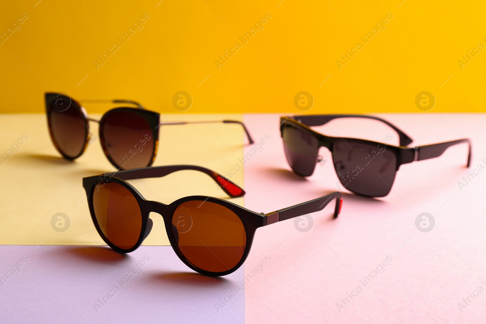 Photo of Stylish sunglasses on color background. Summer time