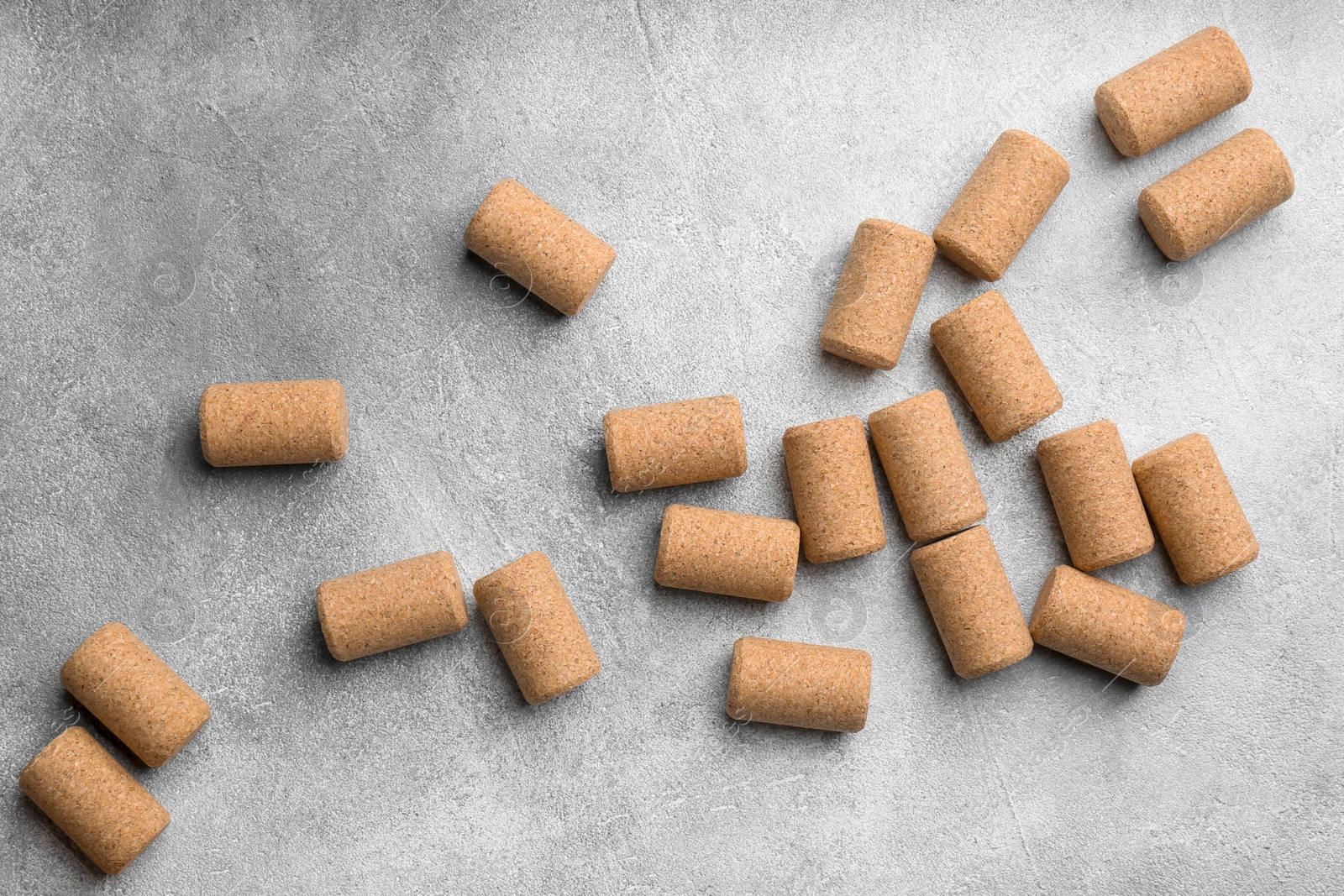 Photo of Wine bottle corks on light grey table, flat lay