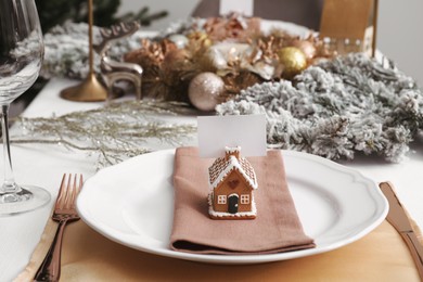 Luxury festive place setting with blank card and beautiful decor for Christmas dinner on white table indoors