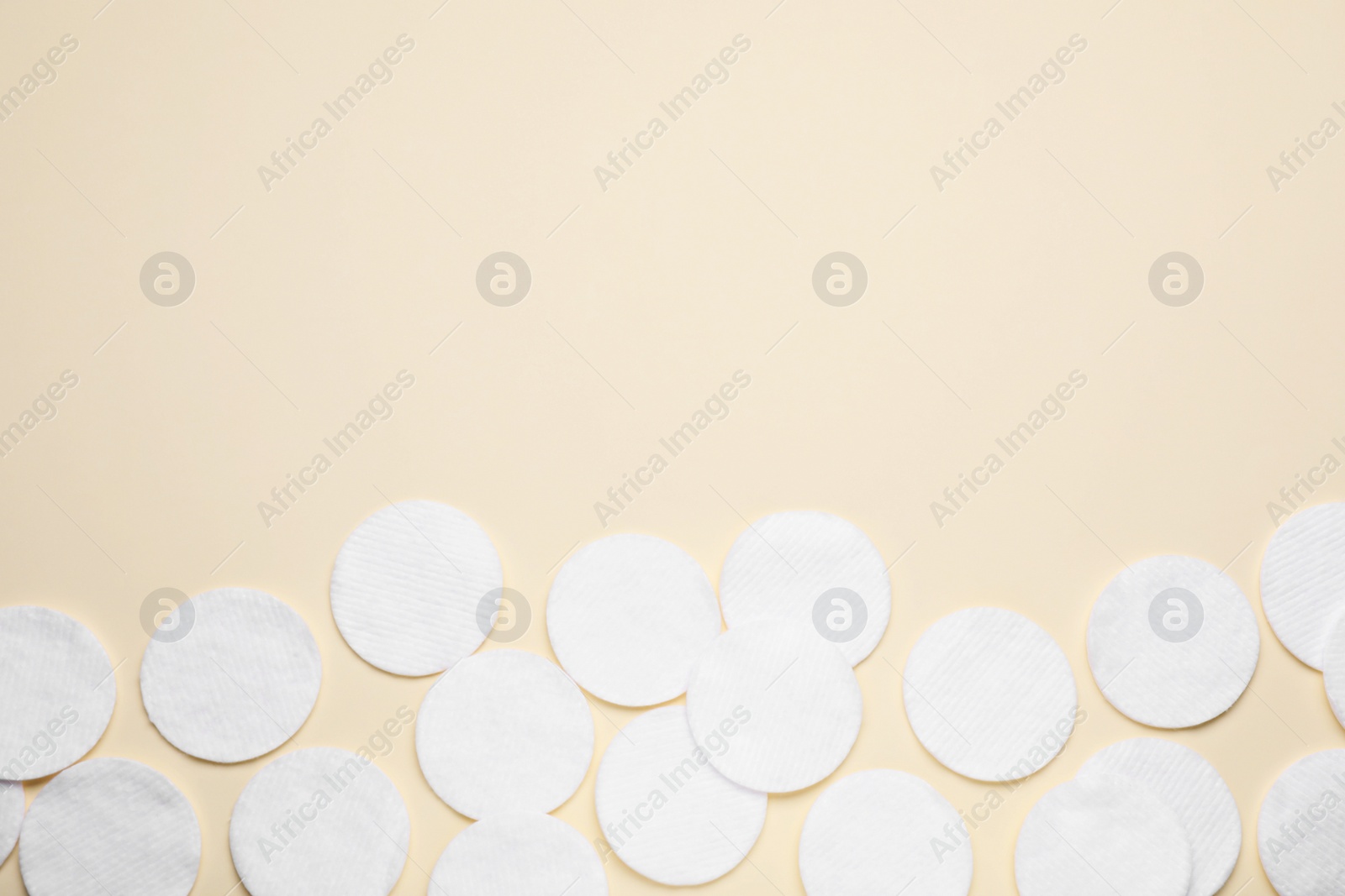 Photo of Many clean cotton pads on yellow background, flat lay. Space for text