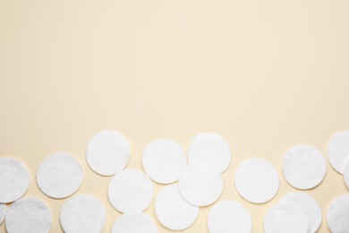 Photo of Many clean cotton pads on yellow background, flat lay. Space for text