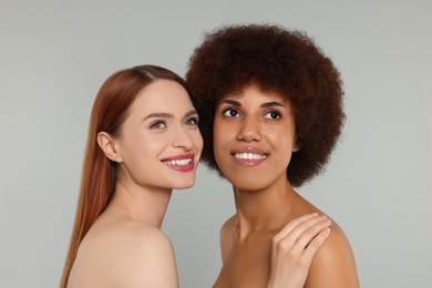 Portrait of beautiful young women on light grey background