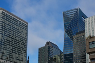 Exterior of different modern skyscrapers against blue sky