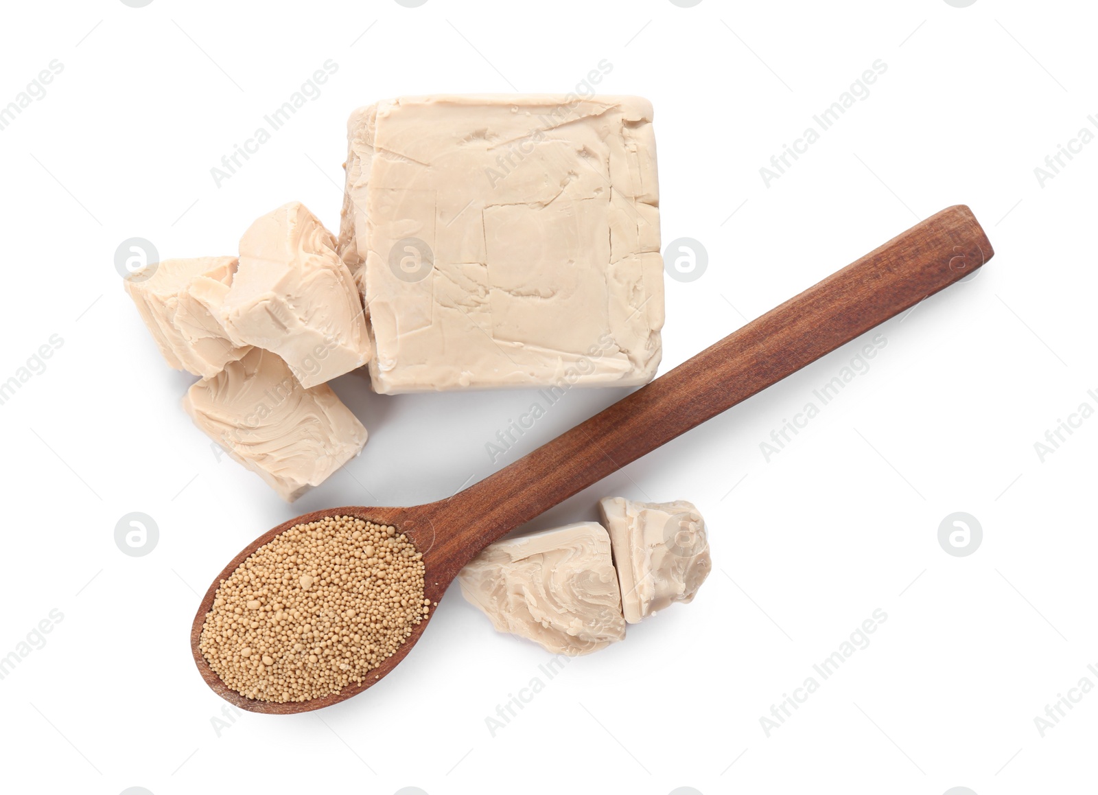 Photo of Compressed and granulated yeast on white background, top view