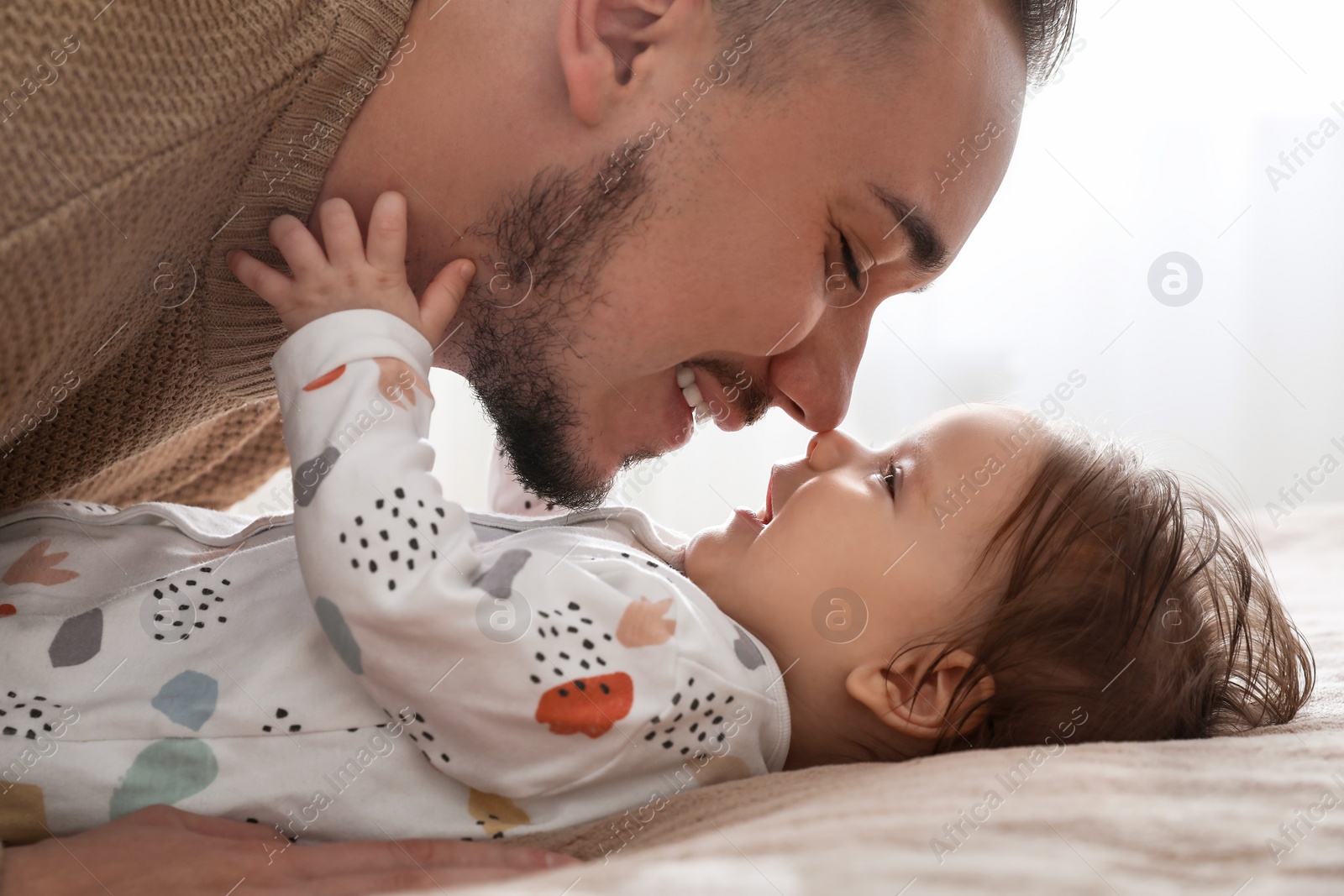 Photo of Father spending time together with his daughter indoors