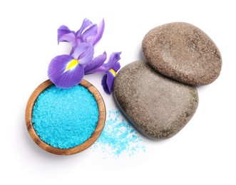 Photo of Light blue sea salt in bowl, spa stones and iris flower isolated on white, top view