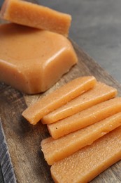 Photo of Tasty sweet quince paste on grey table, closeup