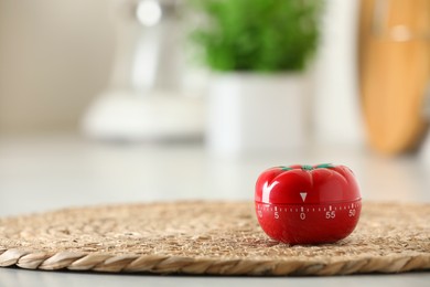 Photo of Kitchen timer in shape of tomato on light table indoors. Space for text