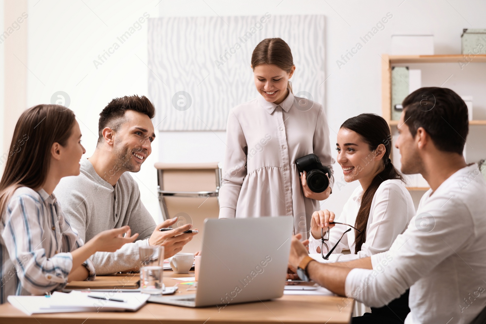 Photo of Team of professional journalists working in office