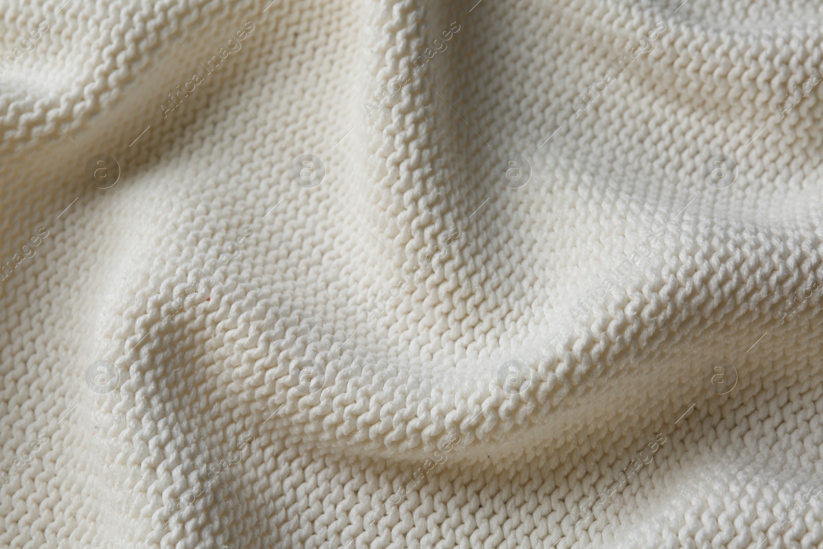 Photo of Beautiful white knitted fabric as background, top view