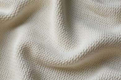 Beautiful white knitted fabric as background, top view