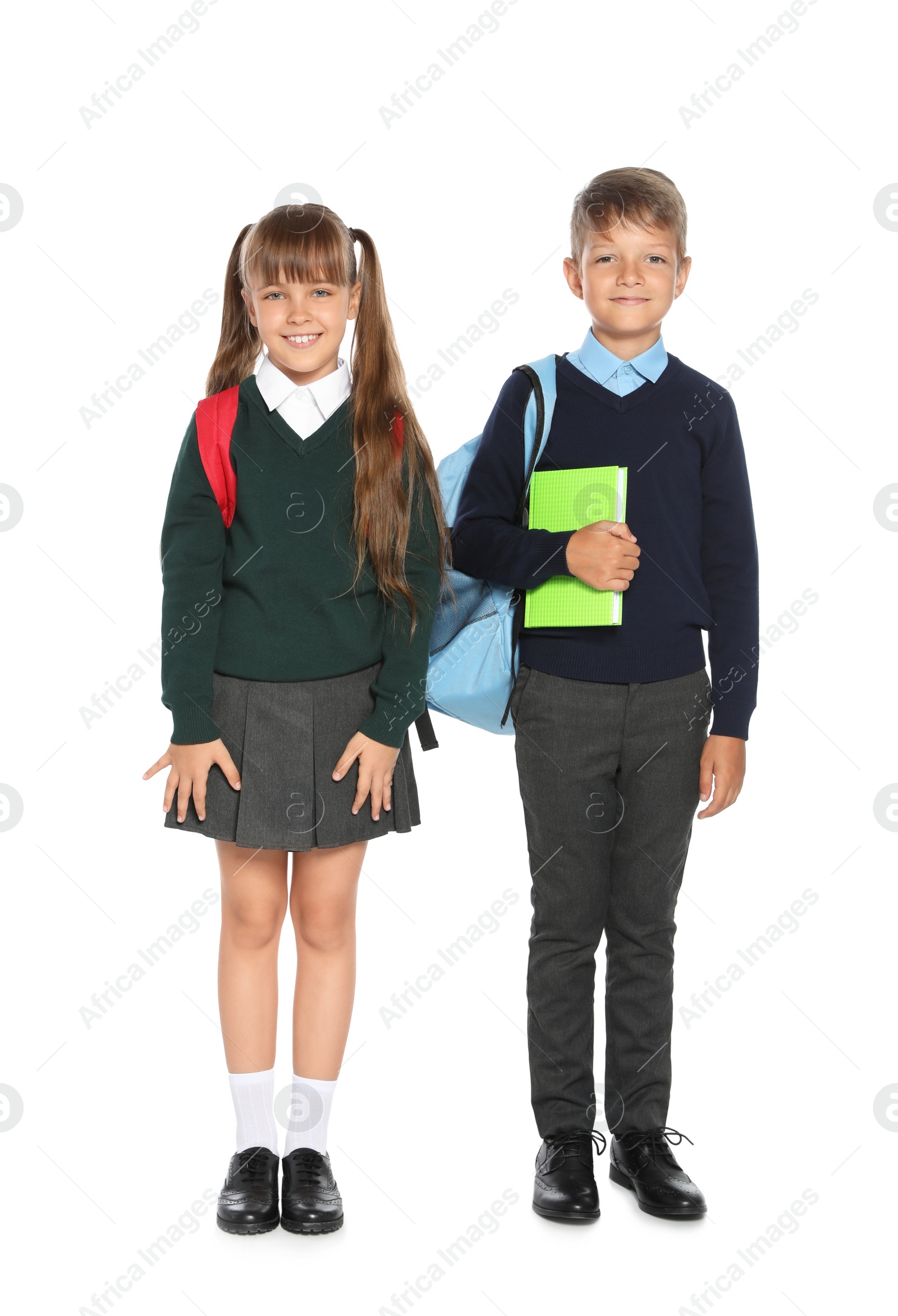 Photo of Little children in stylish school uniform on white background