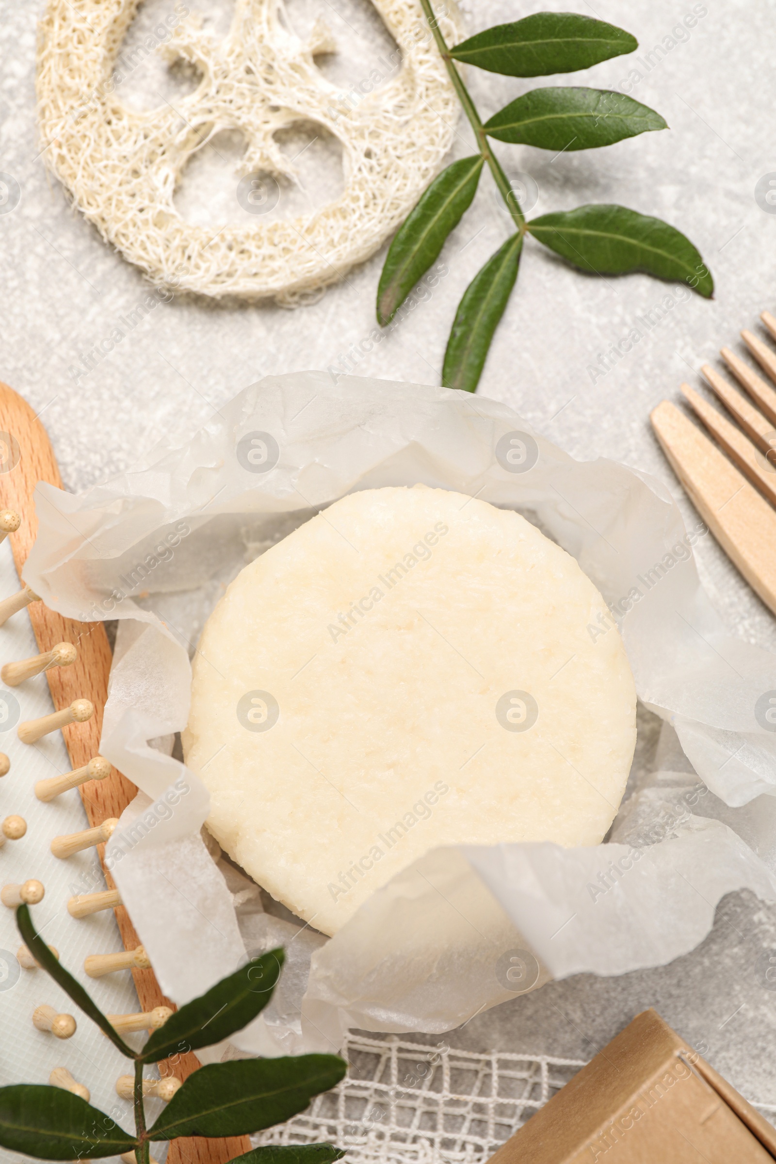 Photo of Flat lay composition with solid shampoo bar on light grey table