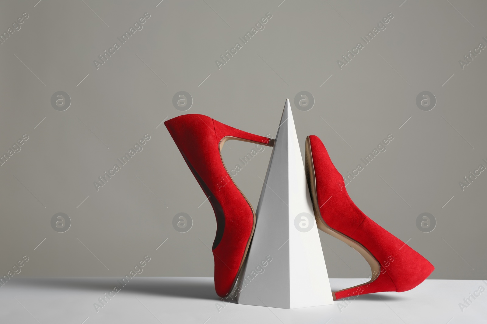 Photo of Composition with elegant female shoes on table against grey background. Space for text