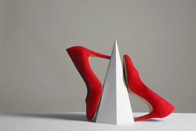 Composition with elegant female shoes on table against grey background. Space for text