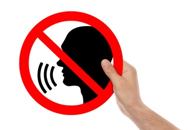 Image of Quiet Please. Man holding prohibition sign with human head image on white background, closeup