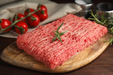 Photo of Board with raw fresh minced meat on wooden table