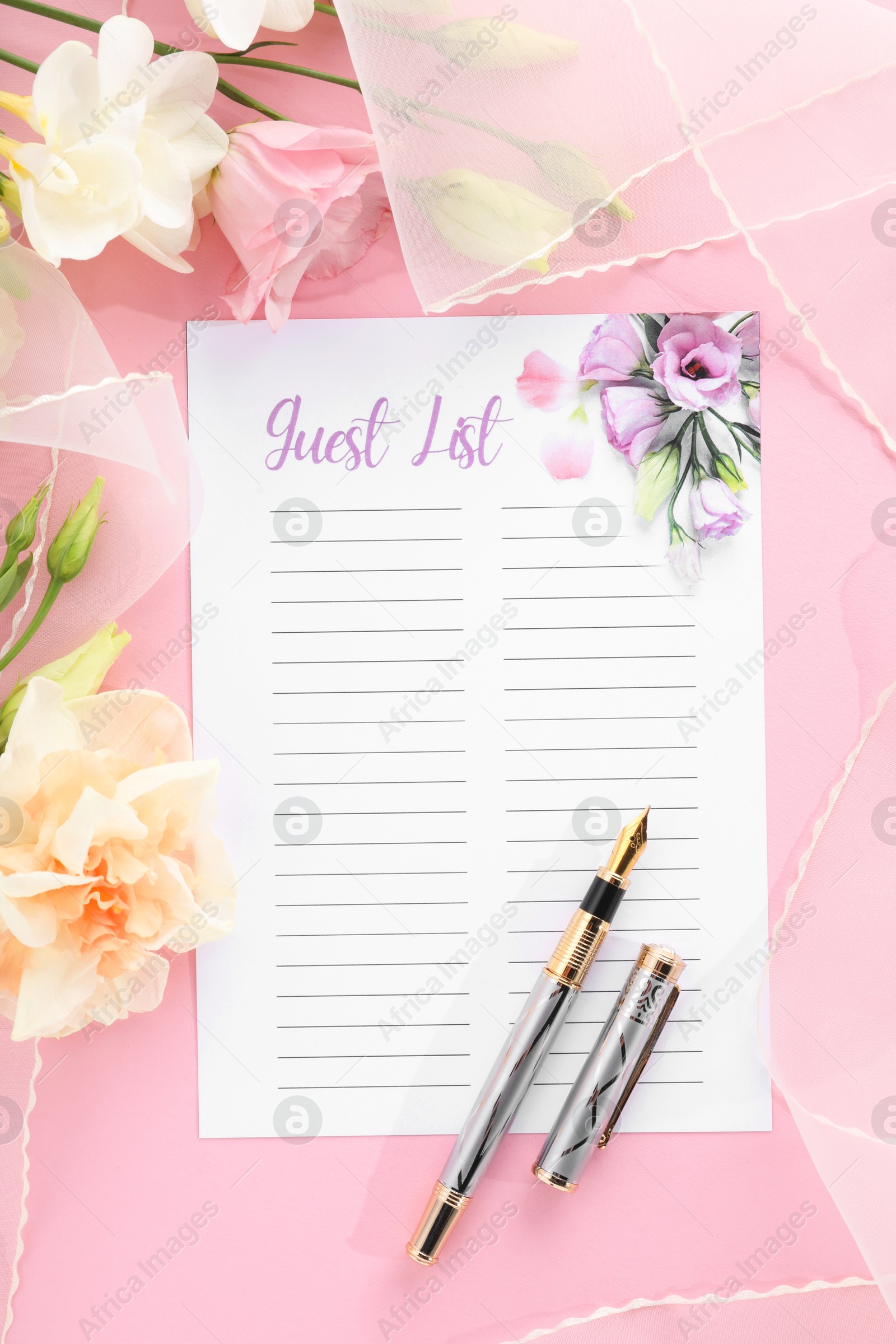 Photo of Guest list, pen, tulle fabric and beautiful flowers on pink background, flat lay. Space for text