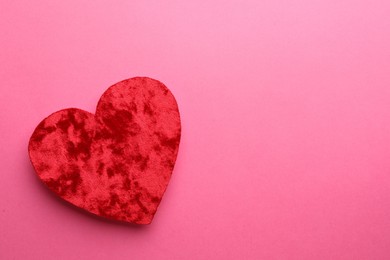 Photo of Red textile heart on pink background, top view. Space for text