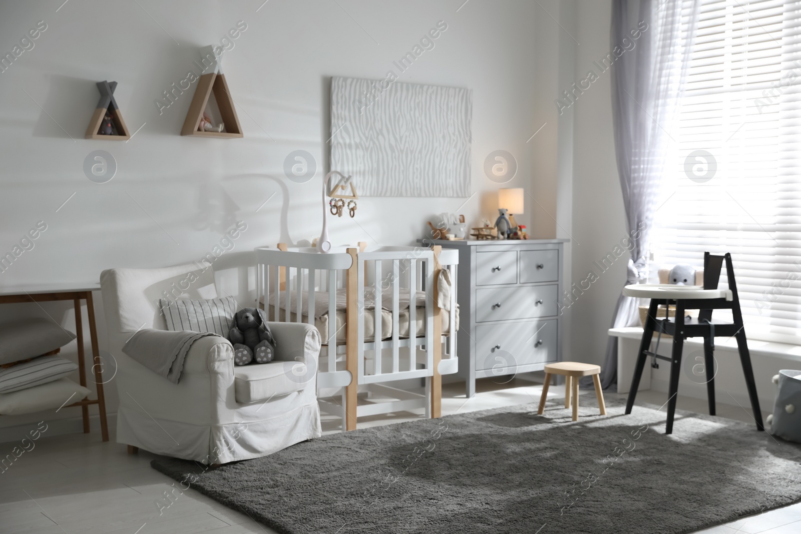 Photo of Baby room interior with crib and highchair. Idea for design