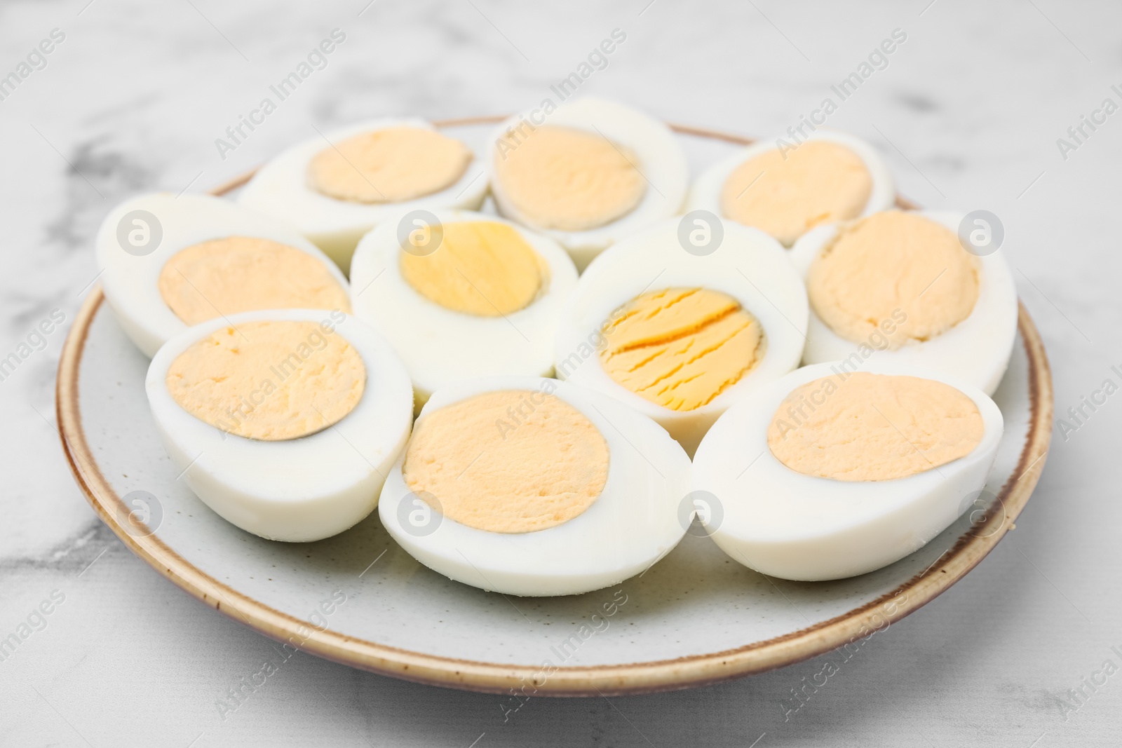 Photo of Fresh hard boiled eggs on white marble table