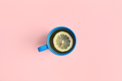 Photo of Cup of tea on pink background, top view