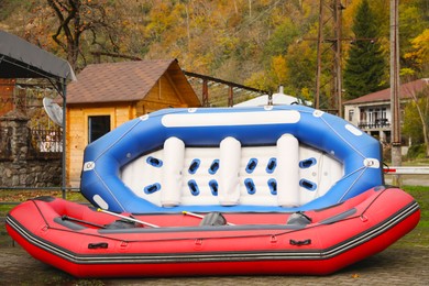 Photo of Inflatable rubber fishing boats and valley in mountain village