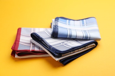 Photo of Different new stylish handkerchiefs on yellow background