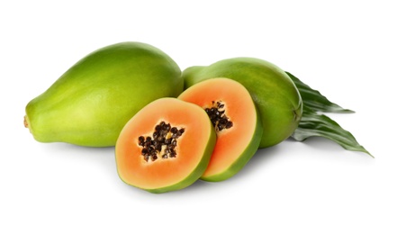 Photo of Fresh ripe papaya fruits with green leaves on white background